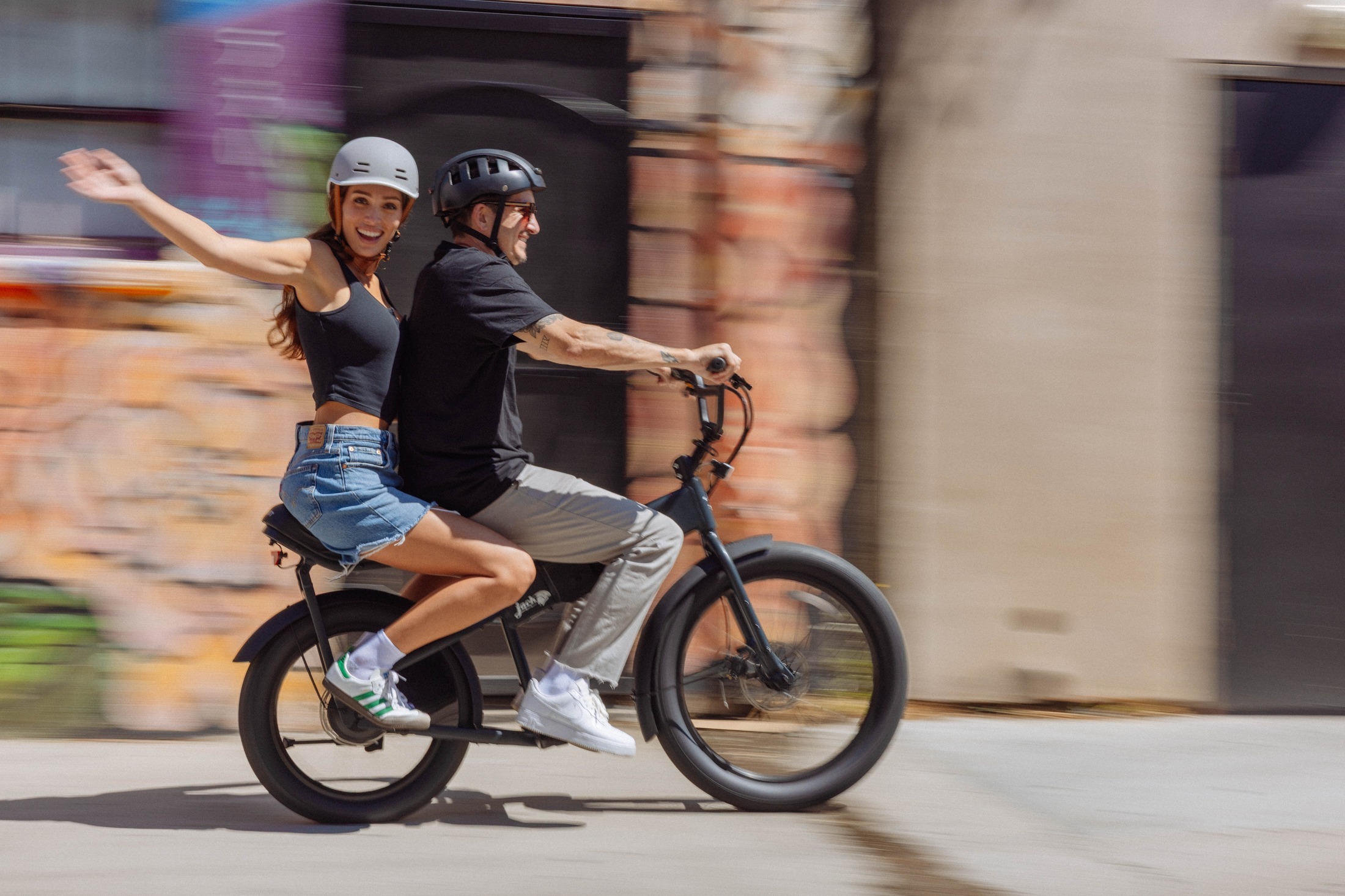 Riders waving, cruising past